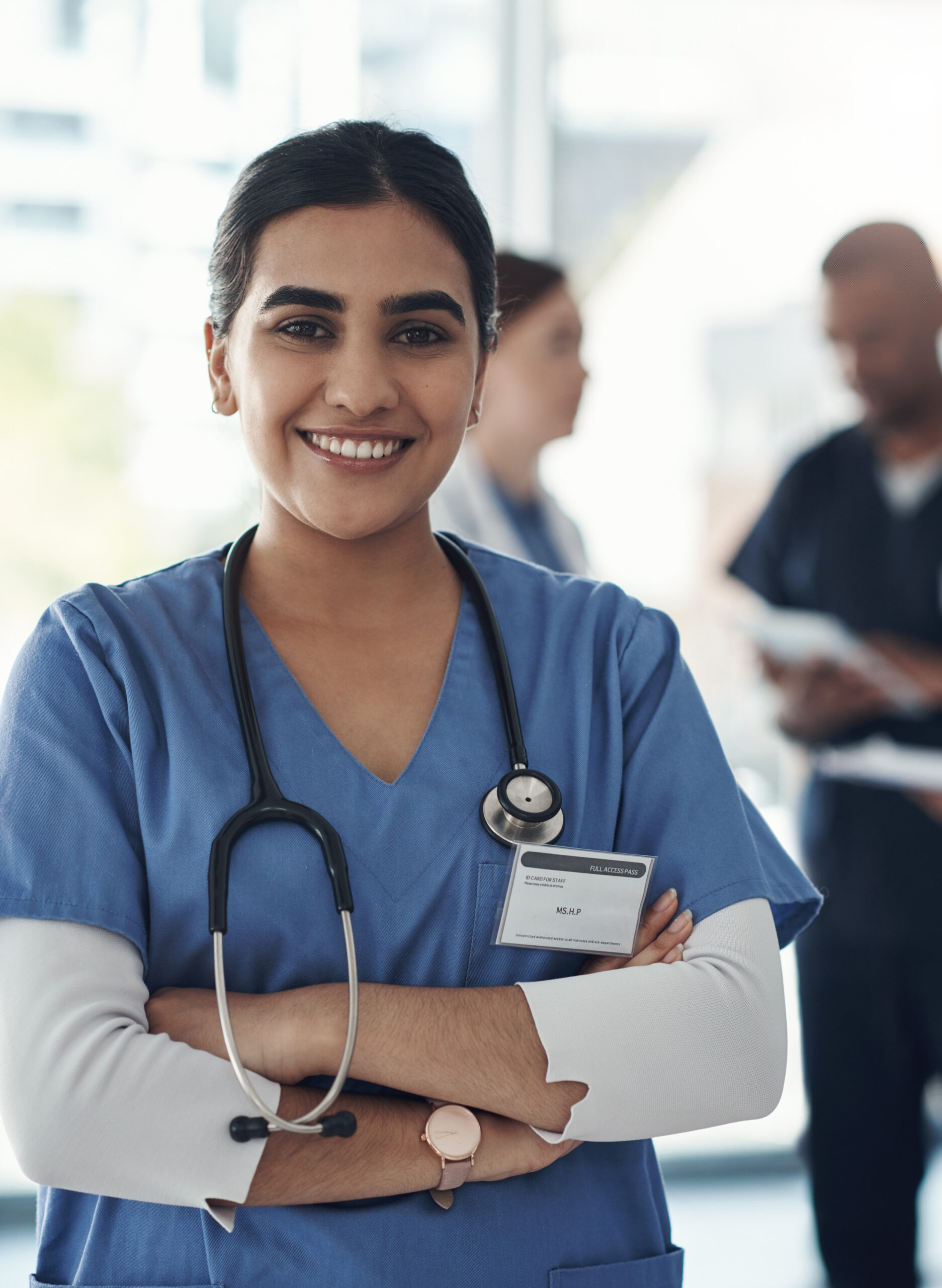 Portrait, nurse and happy woman with arms crossed in hospital for healthcare career, wellness and proud. Face, smile and confident medical professional doctor, surgeon or expert employee coworking.